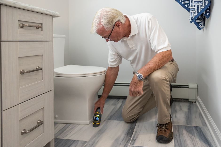 Inspector checking bathroom plumbing