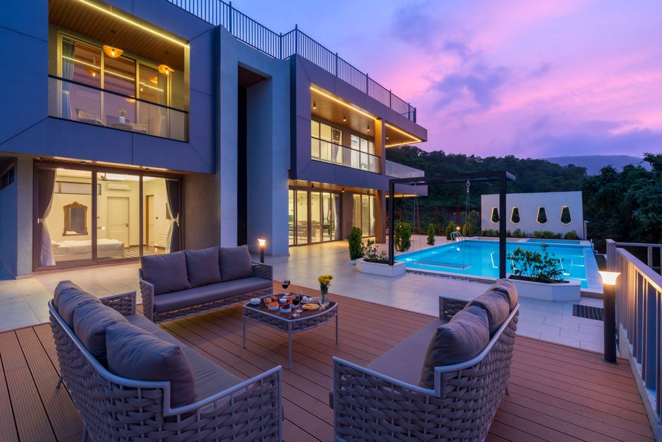 Modern luxury villa with pool at dusk
